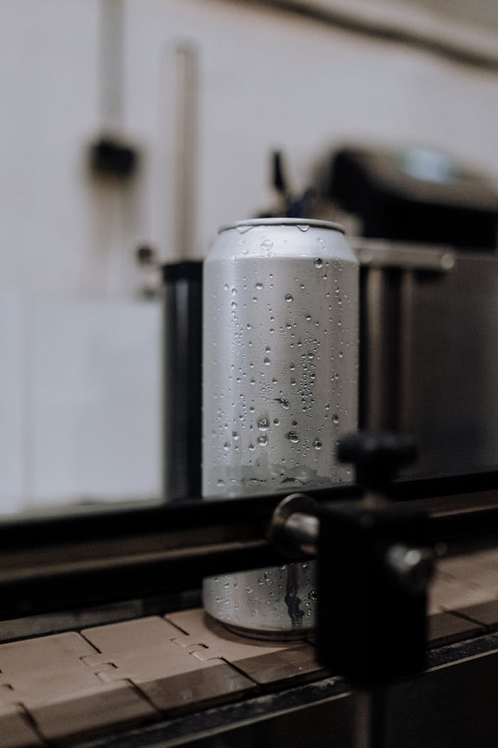 Gray Steel Container on Brown Wooden Table